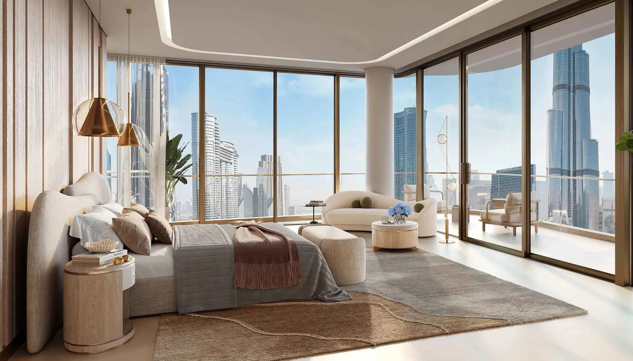 A modern, sunlit bedroom with a large bed, contemporary furniture, and floor-to-ceiling windows offering a panoramic view of a city skyline, including the Burj Khalifa.